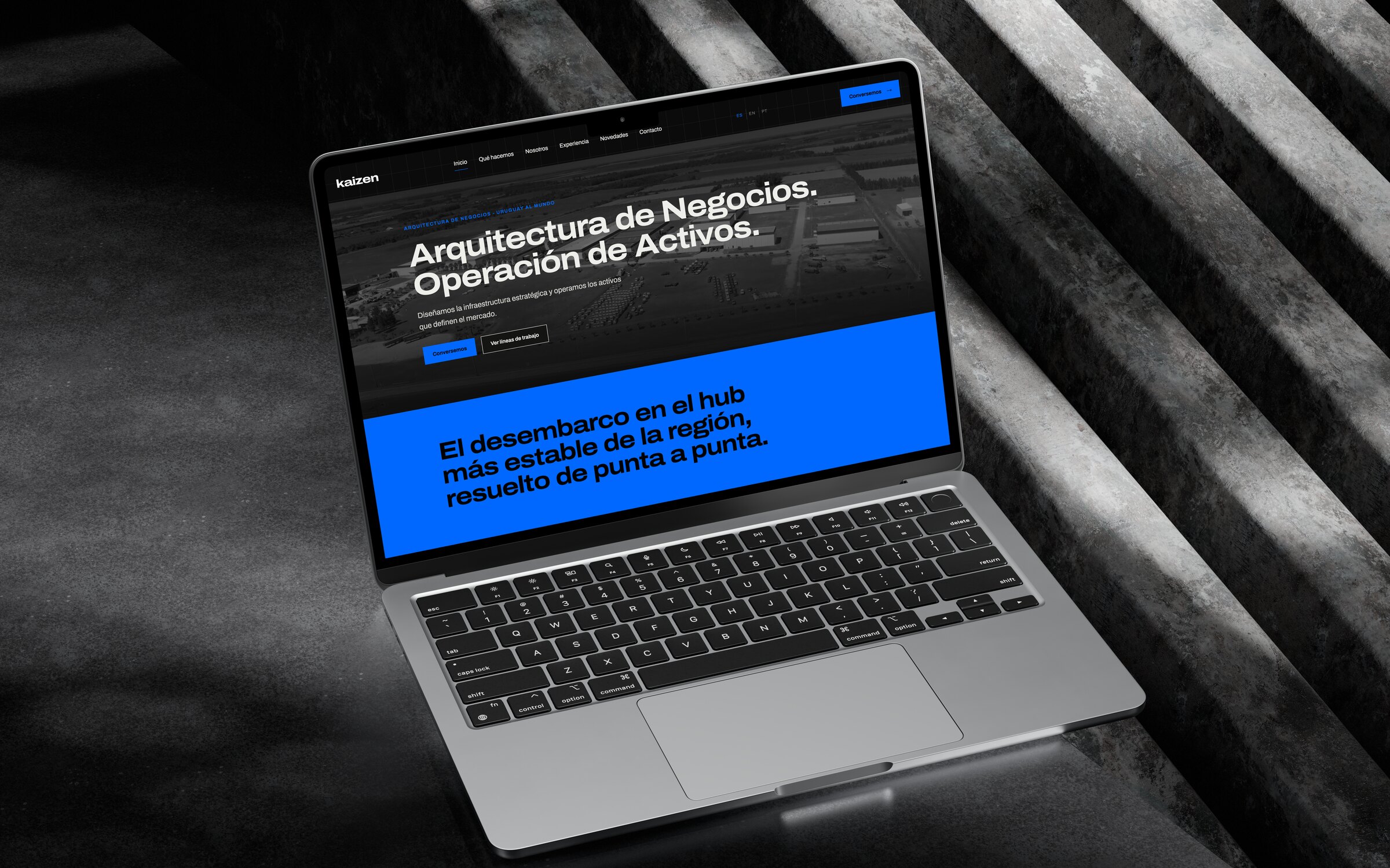 La portada de kaizen.uy en una notebook sobre escalones de hormigón: «Arquitectura de Negocios. Operación de Activos.»
